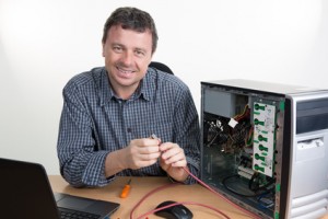 Brunette IT specialist installing ram memory at work